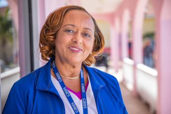 Mercy corps employee on front porch of building.