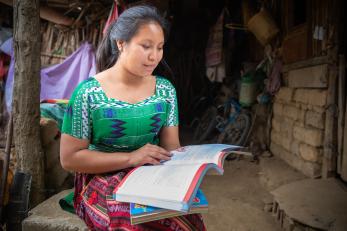 Young guatemalan woman reading a book.