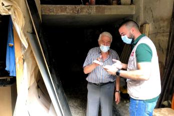 A small business owner speaks with a mercy corps member inside of a store in beirut.