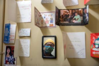 A person looks at various greeting cards they've received from clients over the years.