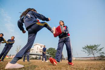 Nepalese women practicing self-defense moves.