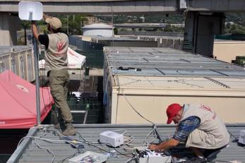 Two individuals install connectivity technology.