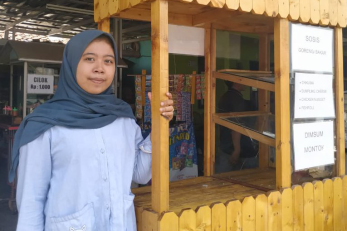 A young person with their food kiosk canteen.