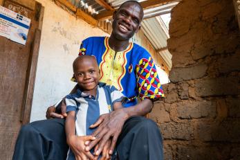 A prospects participant sits with their son. 