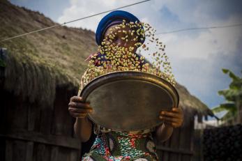 A person tossing grains in a bowl.