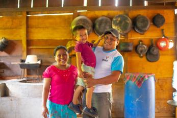 A farmer and their family in their home kitchen.