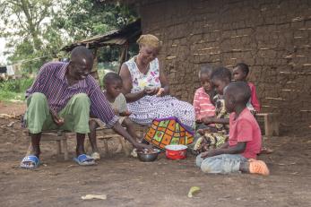 Adults and children having a meal together,