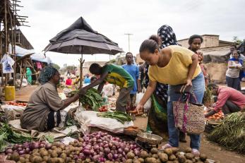 People shopping at an outdoor market. 