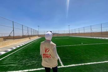 A person overlooking a football pitch.