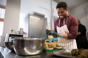 A person preparing food in a kitchen.