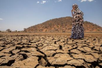 A person walking on dried earth.