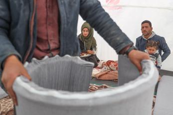 A family receiving an emergency kit from mercy corps.