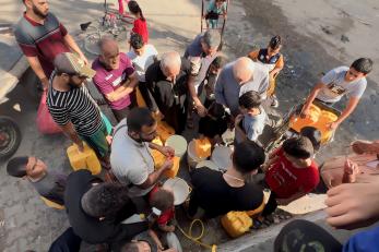 A group of people standing on street in gaza