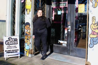 Woman standing outside a business entrance