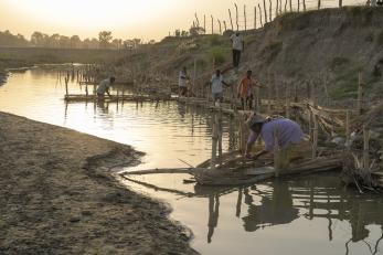 Nepalese community working on restoring riverbank.