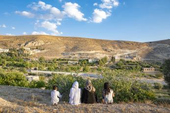 Farat and her daughters look from lebanon toward the hills that mark the syrian border