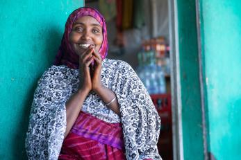 A shopkeeper and pastoralist smiling for the camera.