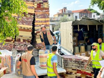 Mercy corps team members unload a truck in lebanon for distribution to program participants