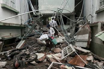 People salvage through rubble after the earthquake in myanmar