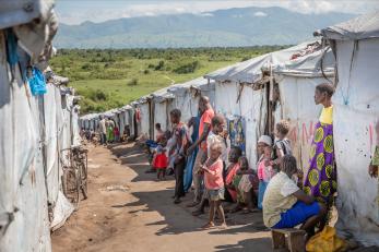 Scene of community members in a displacement camp in the drc.