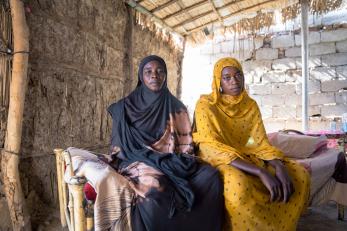 A mother in sudan sits with her daughter