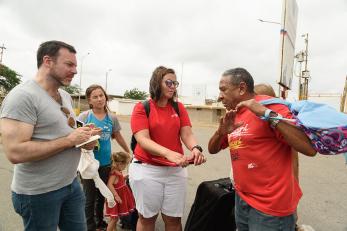 Mercy corps employees speaking with venezuelan family