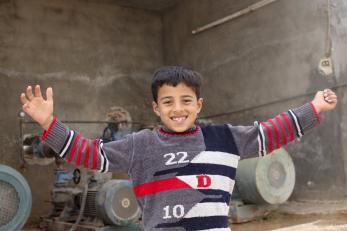 Smiling boy with arms outstretched