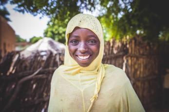 Girl smiling in yellow scarf