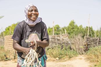 Halma pictured smiling, holding a bunch of rope