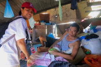 Dewi hanifah, left, visits a tacloban resident