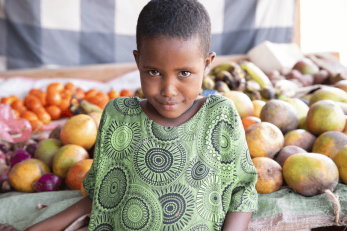 Hadiba pictured in front of a table covered in fruit