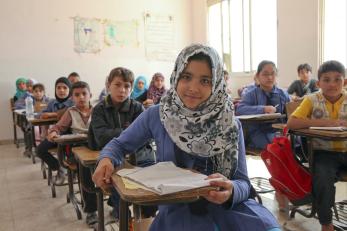 Girl seated at desk in classroom