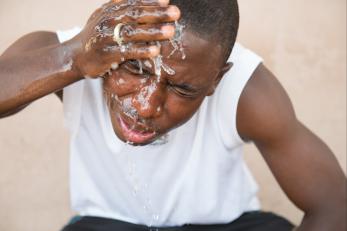 Nigerian man washing face.