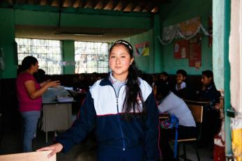 Guatemalan school girl in her classroom.
