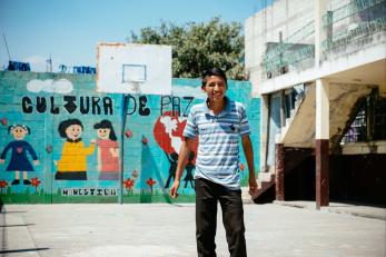 Boy on school yard basketball court.