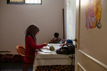 Rayan writing at a table