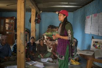 Mercy corps employee speaks to nepalese community group.