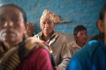 Elder nepalese man in community group.