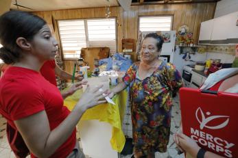 Carmen receiving an emergency cash distribution from mercy corps