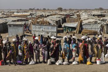 Women queuing in a displacement shelter