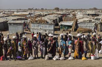 Line of people outside with bags