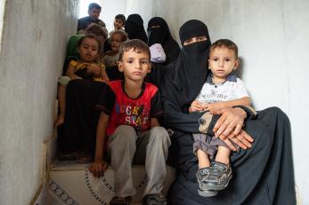 Mothers and children sitting on a staircase in yemen
