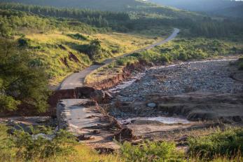 A damaged road with a washed-out bridge in zimbabwe