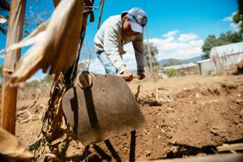 A boy working at a plot of farmland in guatemala