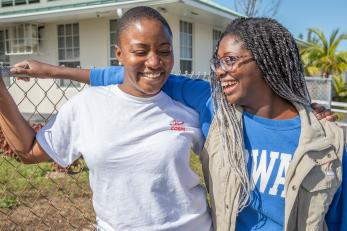 Two mercy corps colleagues standing together.