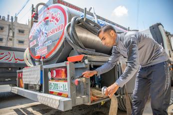 Palestinian water tender truck and its operator.