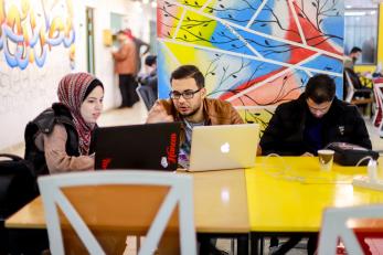 Gaza sky geeks employees work together in common space.