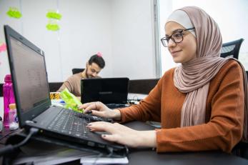 An employee uses a laptop. 