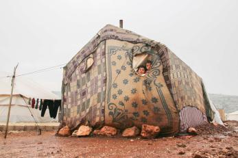 Two children look out the small window of their family’s tent, after a huge rainstorm hit al-rayyan camp in the area northwest of idlib.