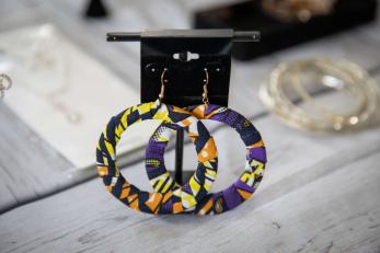 A pair of earrings on a display.